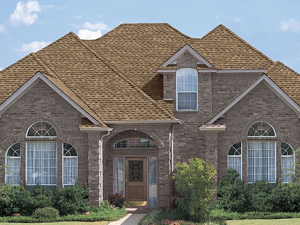 Stone front home with tan roof.